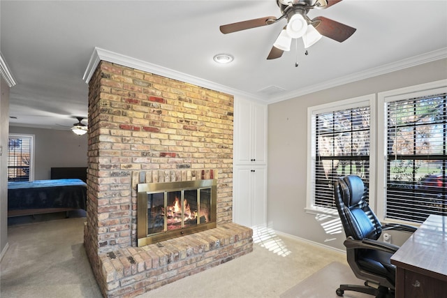 home office featuring a fireplace, light carpet, crown molding, and ceiling fan