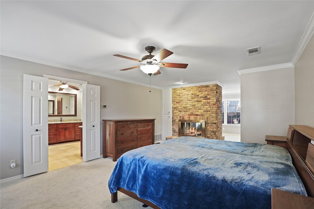 bedroom with ceiling fan, sink, a brick fireplace, crown molding, and light carpet