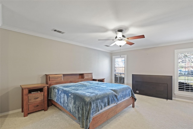 carpeted bedroom with ceiling fan and crown molding