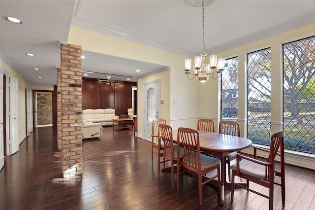 dining area featuring a notable chandelier, plenty of natural light, ornamental molding, and decorative columns