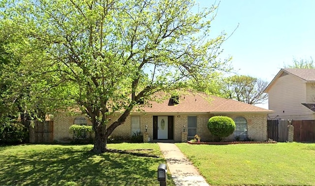 ranch-style home with a front lawn