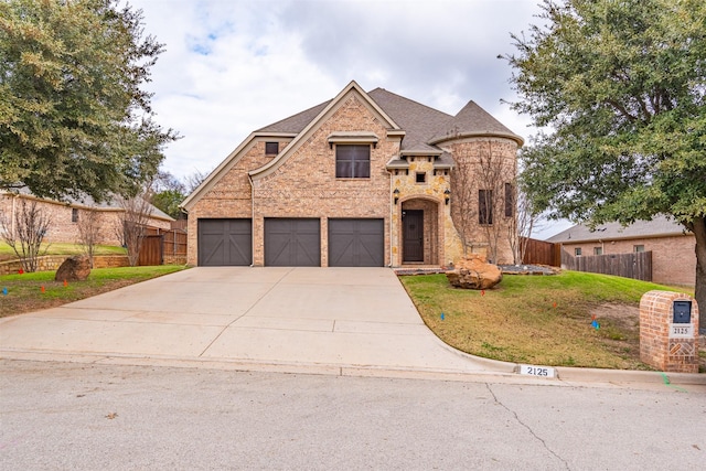 view of front facade featuring a garage and a front lawn