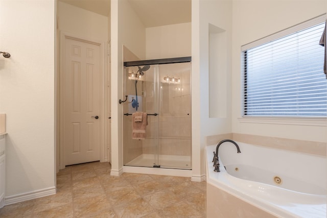 bathroom featuring a shower stall, a whirlpool tub, and plenty of natural light
