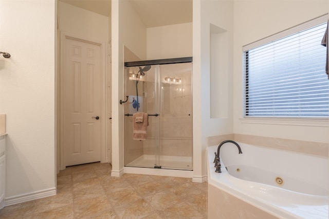 bathroom with vanity and independent shower and bath