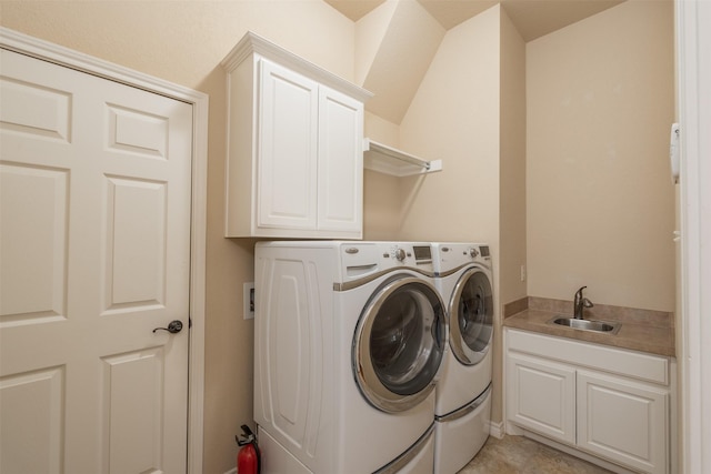 washroom featuring cabinets, separate washer and dryer, and sink