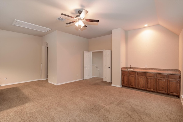 carpeted empty room with ceiling fan and lofted ceiling