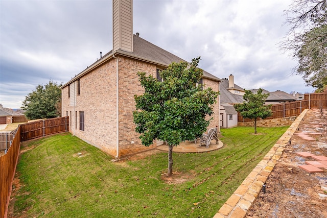 view of home's exterior featuring a lawn, a patio area, and a storage shed