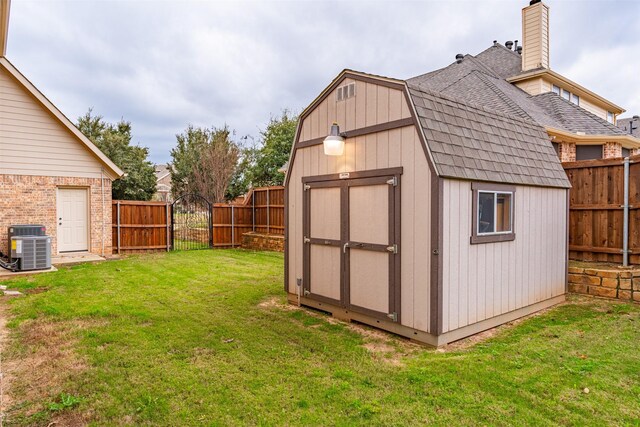 view of outbuilding featuring a lawn and central AC