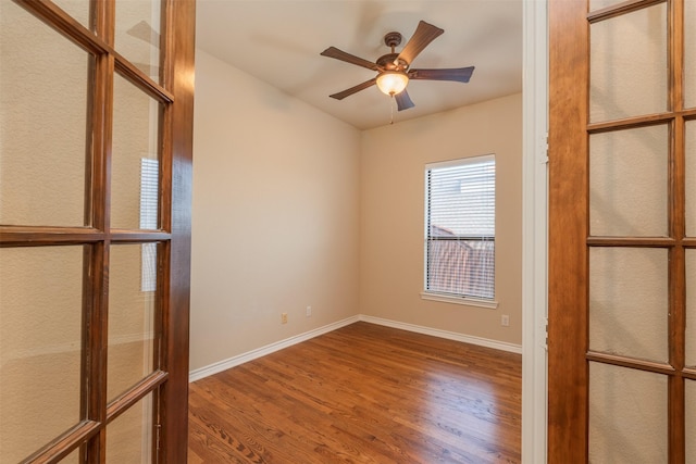 spare room featuring ceiling fan and hardwood / wood-style flooring