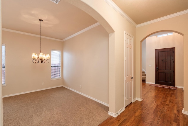 interior space with a chandelier, dark hardwood / wood-style flooring, and crown molding