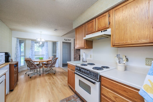 kitchen featuring light hardwood / wood-style flooring, a chandelier, a textured ceiling, pendant lighting, and white appliances