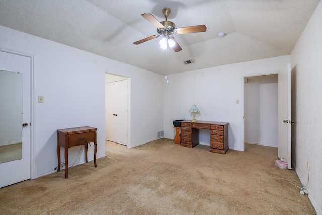 carpeted office featuring vaulted ceiling and ceiling fan