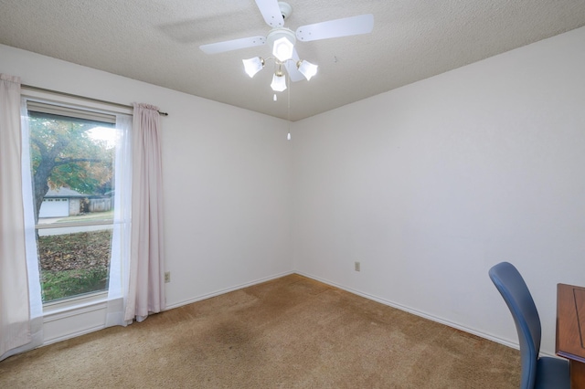 spare room with ceiling fan, carpet floors, and a textured ceiling