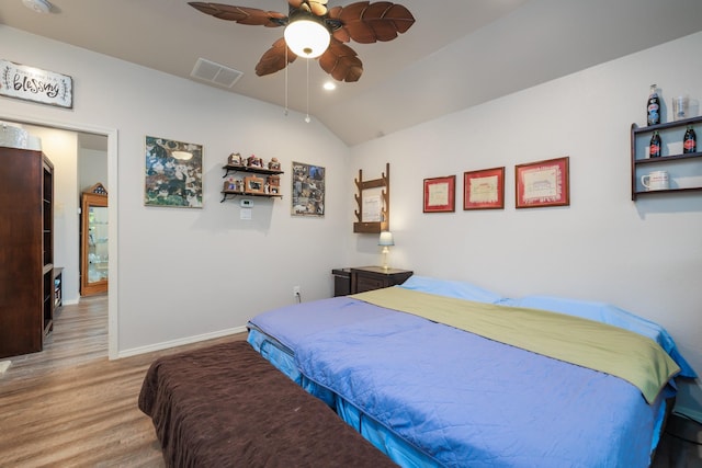 bedroom featuring light wood-type flooring, ceiling fan, and lofted ceiling