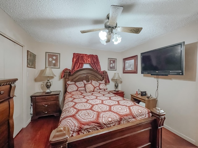 bedroom with ceiling fan, dark wood-type flooring, and a textured ceiling