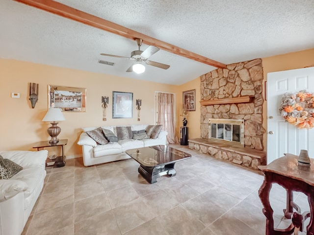 tiled living room featuring ceiling fan, a fireplace, a textured ceiling, and vaulted ceiling with beams