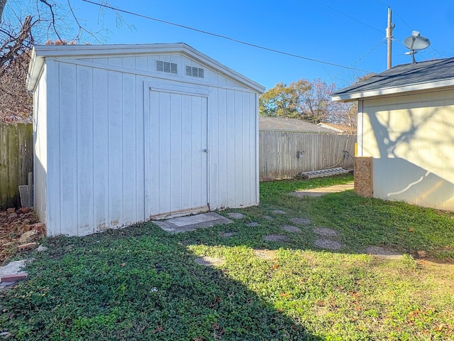 view of outbuilding with a yard