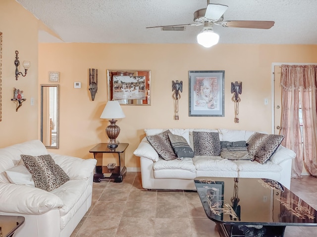 tiled living room with a textured ceiling and ceiling fan