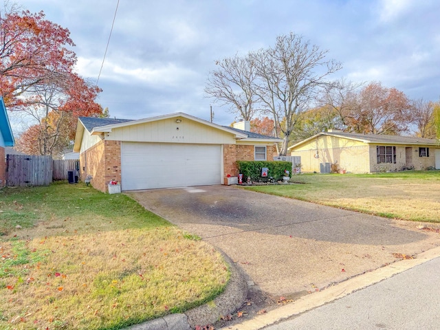 ranch-style home featuring a garage, central AC, and a front yard