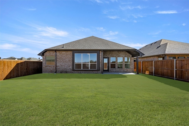 back of house with a lawn