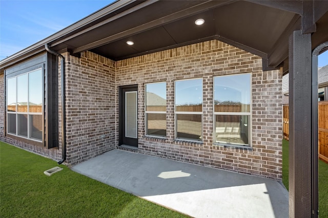 view of exterior entry featuring a patio