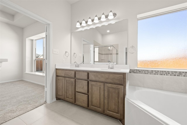 bathroom with vanity, tile patterned floors, and shower with separate bathtub