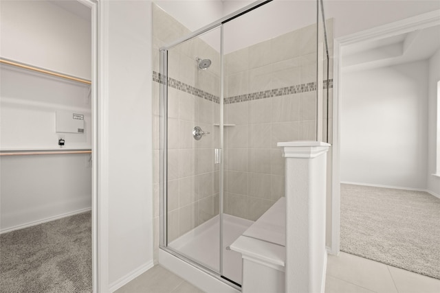 bathroom featuring tile patterned floors and a shower with shower door