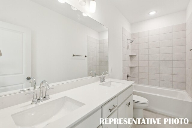 full bathroom with vanity, toilet, and tiled shower / bath combo