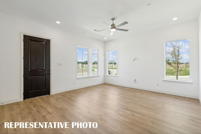 empty room featuring ceiling fan and light wood-type flooring