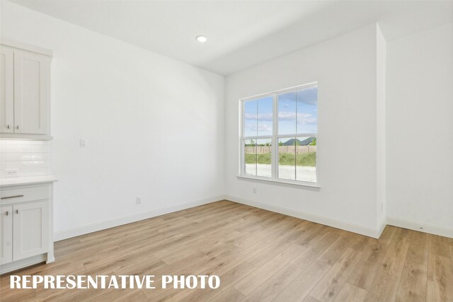 unfurnished dining area with light hardwood / wood-style floors