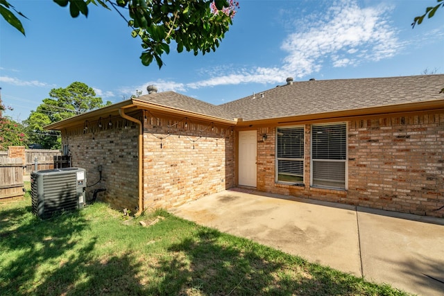 back of house with a yard, a patio, and cooling unit