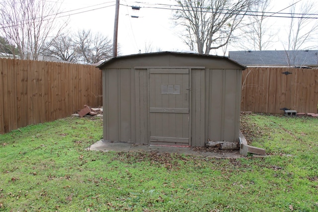 view of outbuilding with a yard