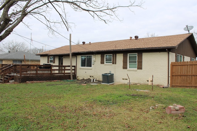 back of property featuring a wooden deck, a yard, and central AC unit