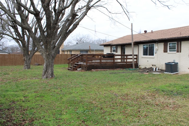 view of yard with central AC unit and a deck