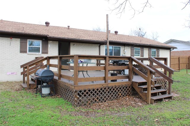 rear view of property featuring a yard and a deck