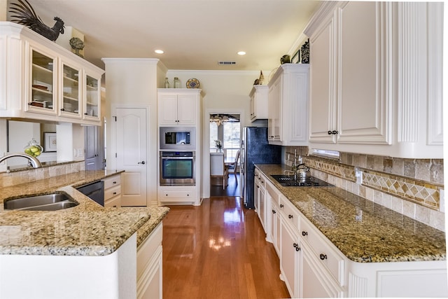 kitchen featuring sink, dark hardwood / wood-style floors, black appliances, white cabinets, and stone countertops