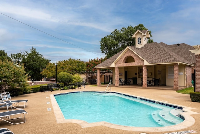 community pool featuring a patio area and fence