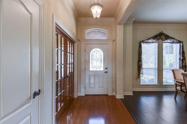 foyer featuring dark hardwood / wood-style flooring and ornamental molding