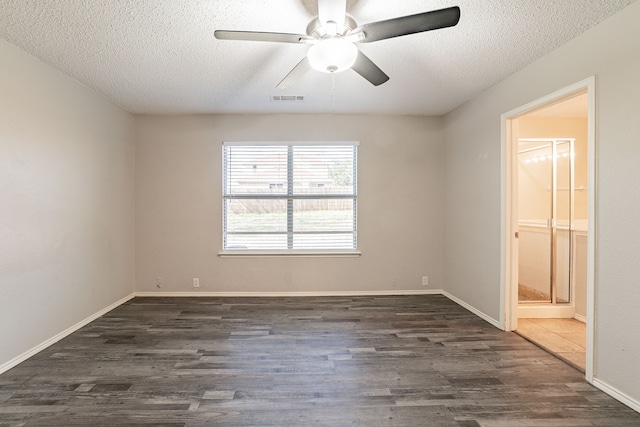 unfurnished room with ceiling fan, dark wood-type flooring, and a textured ceiling