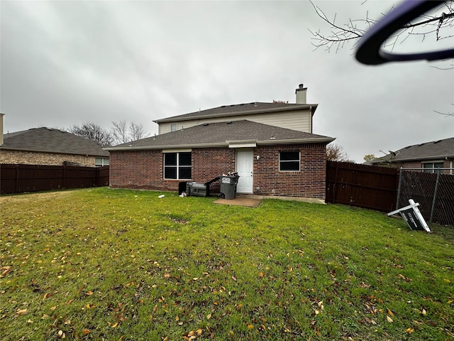 back of property featuring a lawn