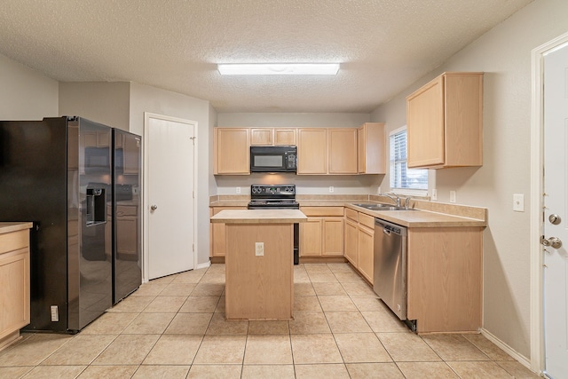 kitchen with sink, a kitchen island, black appliances, light tile patterned flooring, and light brown cabinets