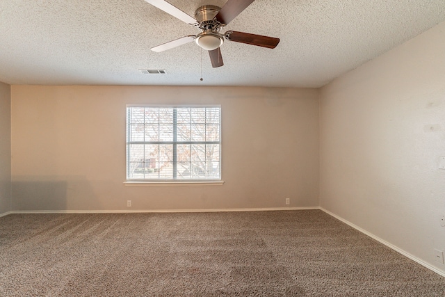 carpeted empty room featuring ceiling fan and a textured ceiling