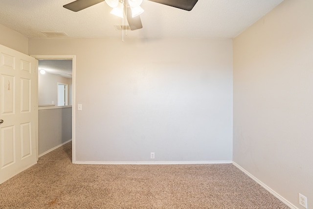 spare room with ceiling fan, carpet floors, and a textured ceiling