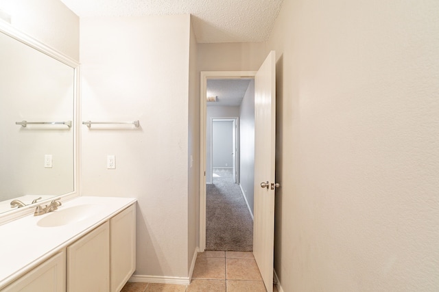 bathroom with vanity, tile patterned floors, and a textured ceiling