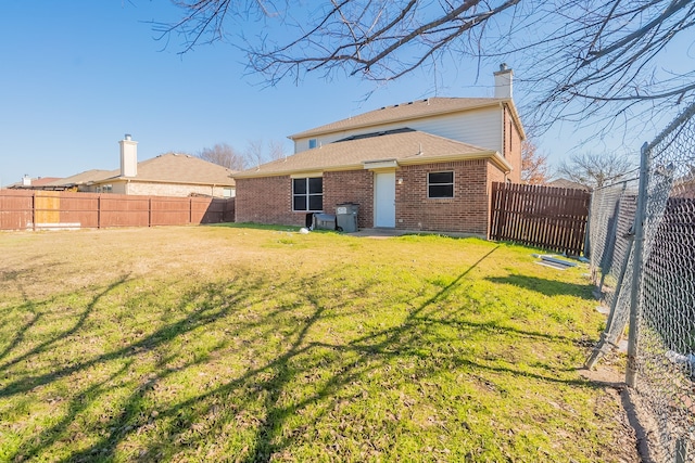 back of house with a yard