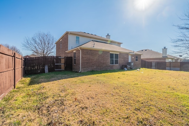 rear view of house with a lawn