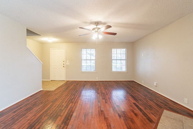 spare room with ceiling fan, hardwood / wood-style floors, and a textured ceiling