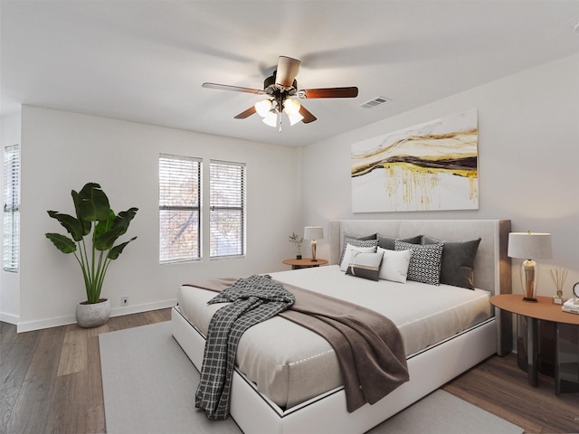 bedroom with ceiling fan and dark hardwood / wood-style floors