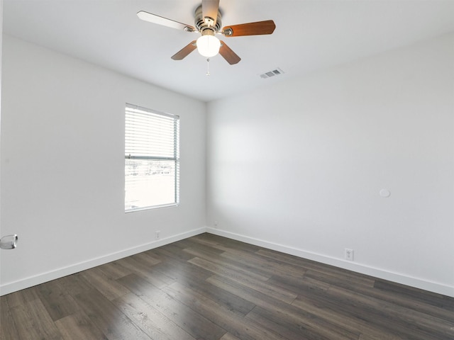 unfurnished room with dark hardwood / wood-style flooring and ceiling fan