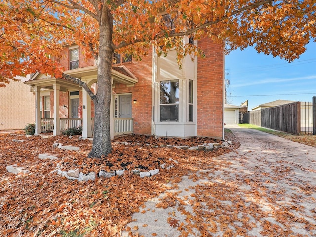 exterior space with a porch, a garage, and an outdoor structure